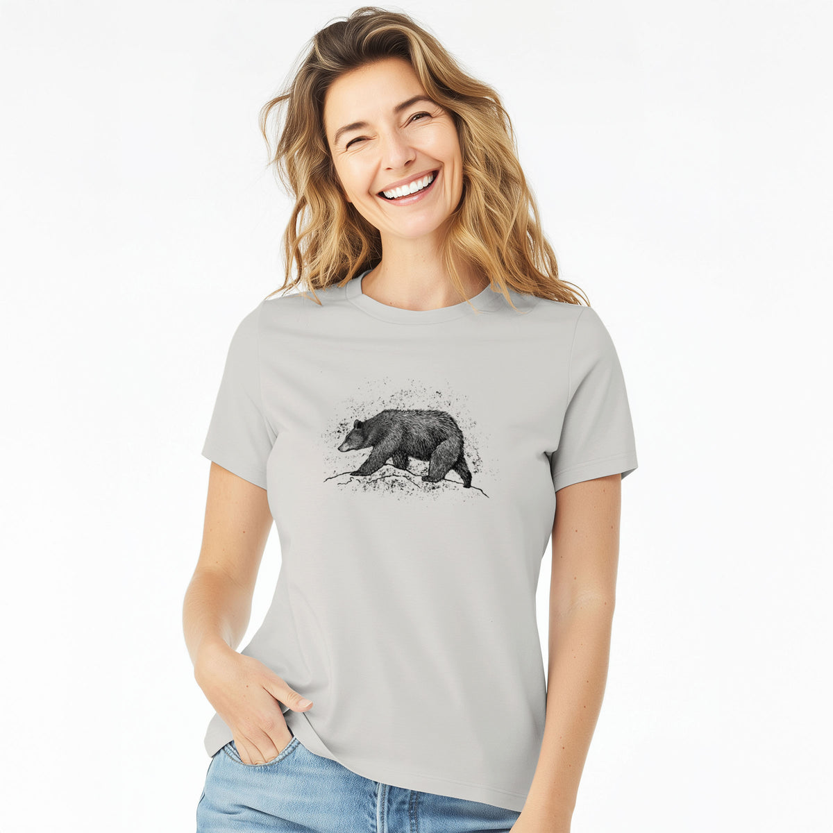 Woman wearing a lunar grey women's relaxed fit cotton t-shirt printed with a detailed black ink sketch of a black bear walking across rocky ground.