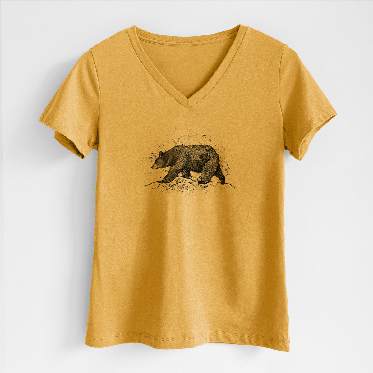 Honeycomb yellow women's relaxed fit cotton V-neck t-shirt laid flat, printed with a detailed black ink sketch of a black bear walking across rocky ground.