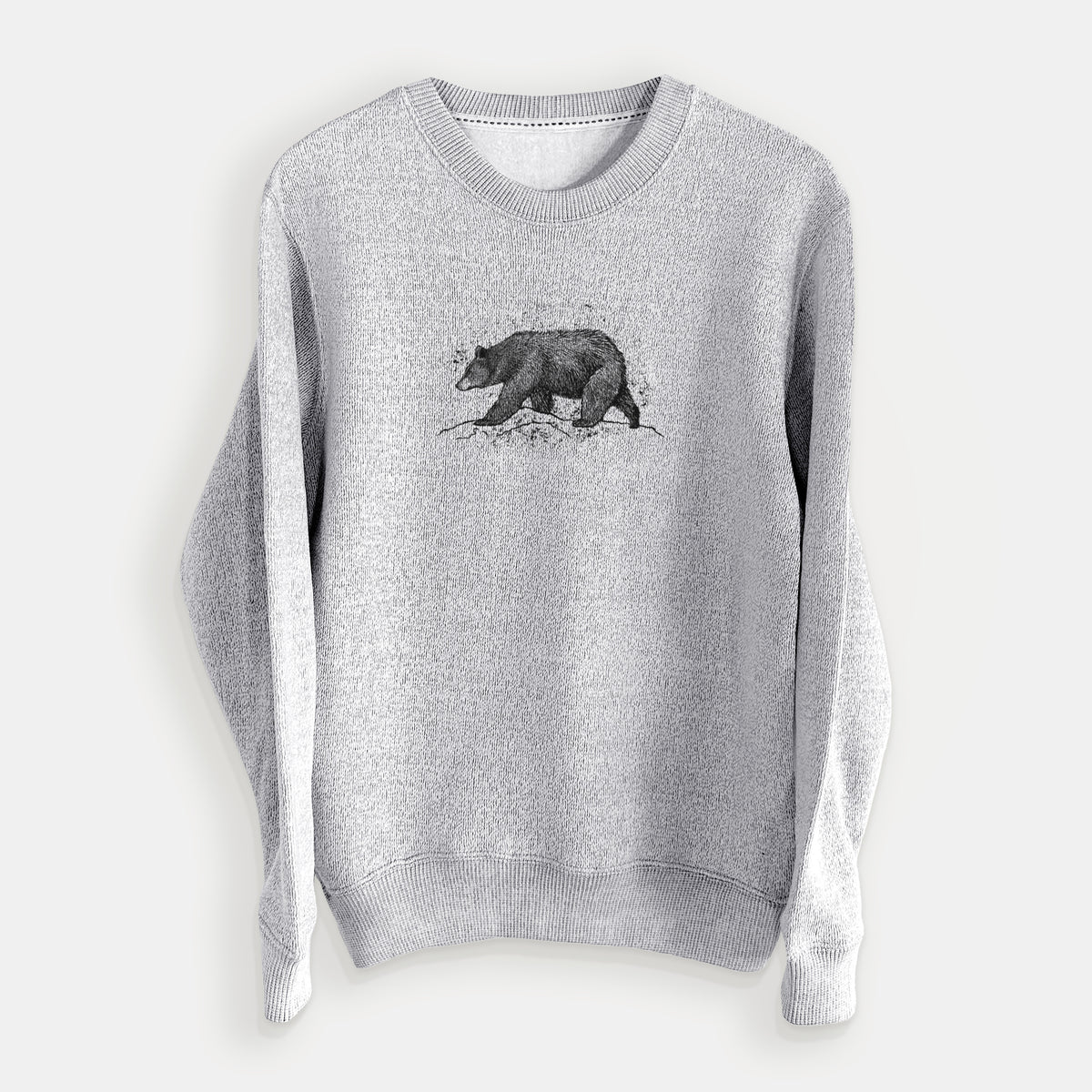 Salt and pepper knit sweatshirt laid flat, printed with a detailed black ink sketch of a black bear walking across rocky ground.