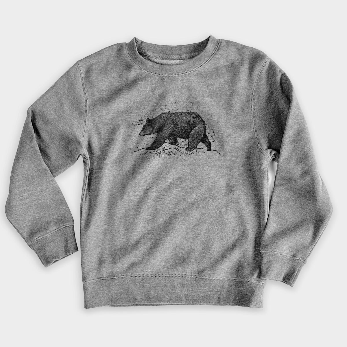 Nickel grey youth crewneck sweatshirt laid flat, printed with a detailed black ink sketch of a black bear walking across rocky ground.