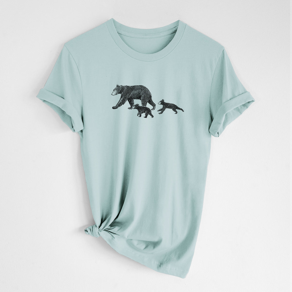 Dusty blue lightweight cotton t-shirt laid flat with the sleeves rolled, printed with a black ink illustration of a mother black bear walking with two cubs.
