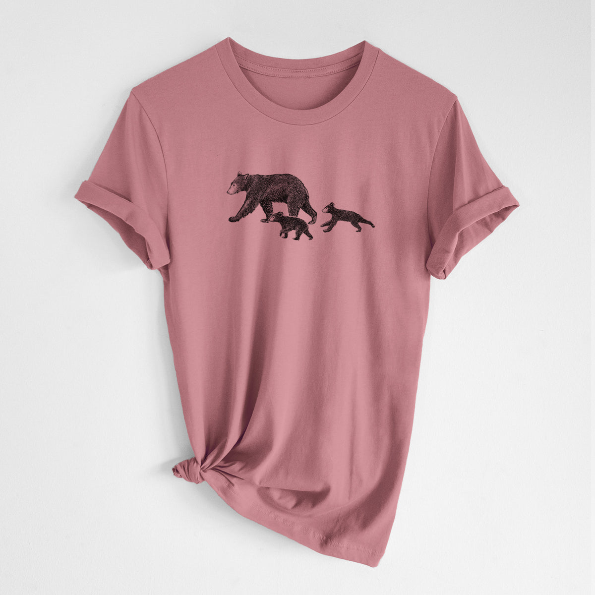 Mauve pink lightweight cotton t-shirt laid flat with the sleeves rolled, printed with a black ink illustration of a mother black bear walking with two cubs.