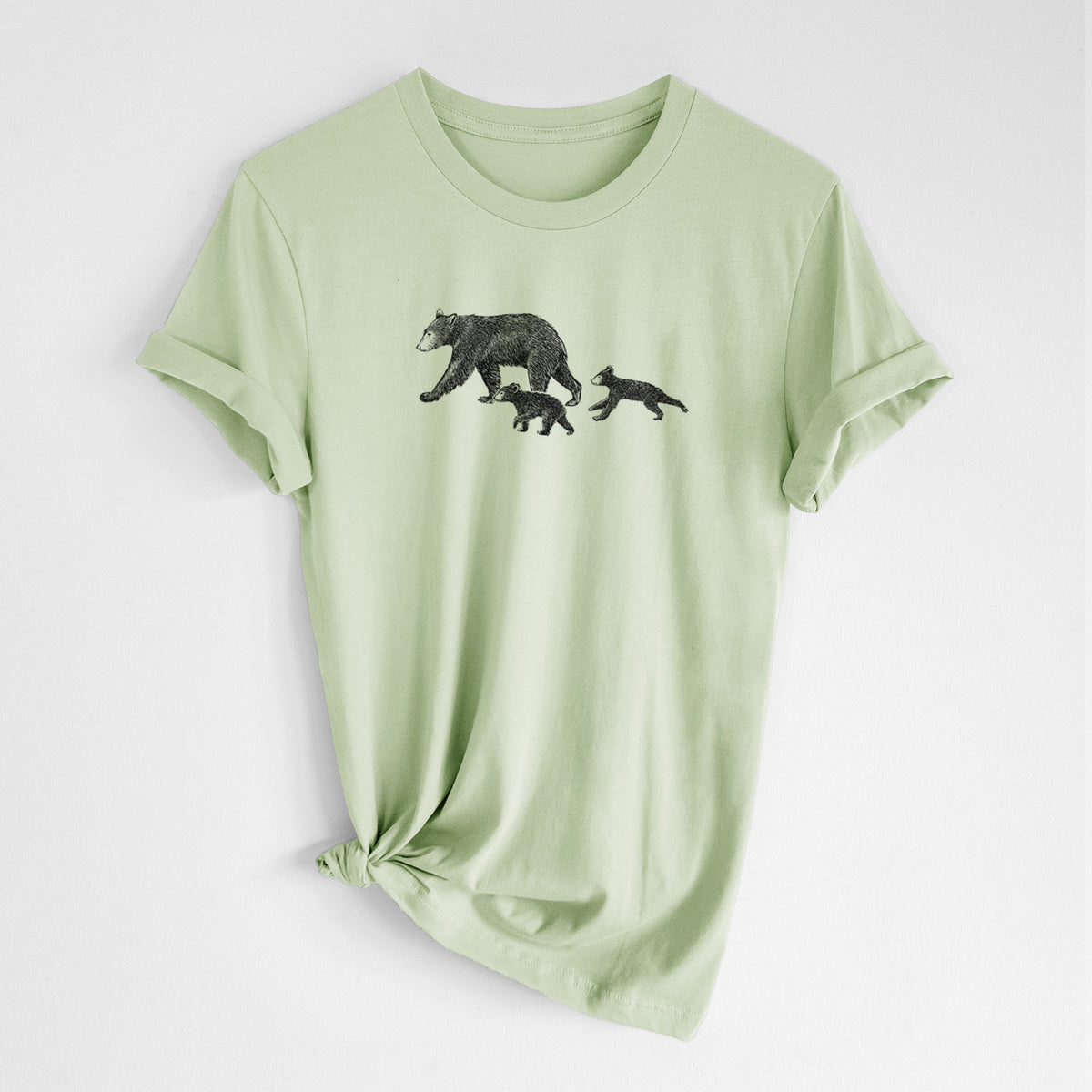 Spring green lightweight cotton t-shirt laid flat with the sleeves rolled, printed with a black ink illustration of a mother black bear walking with two cubs.