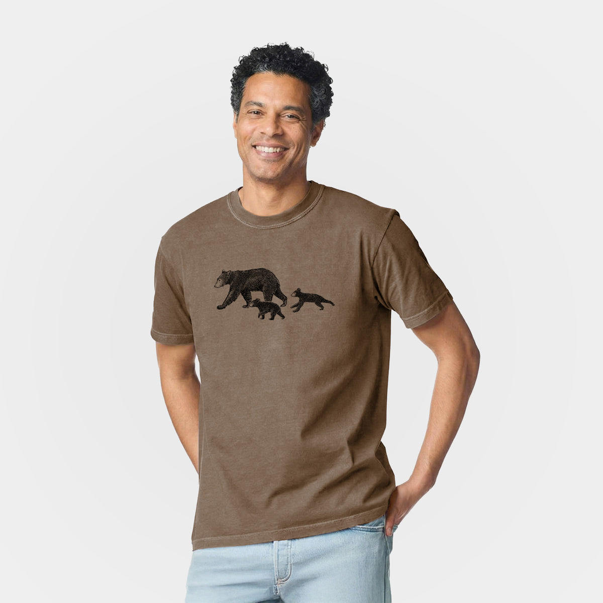 Man wearing a Comfort Colors t-shirt printed with a black ink illustration of a mother black bear walking with two cubs.