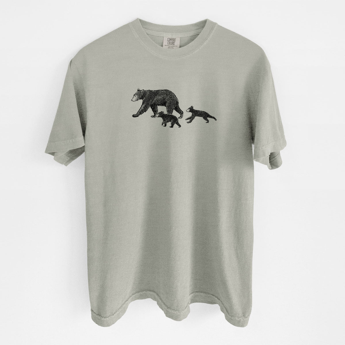 Sandstone beige Comfort Colors t-shirt laid flat, printed with a black ink illustration of a mother black bear walking with two cubs.
