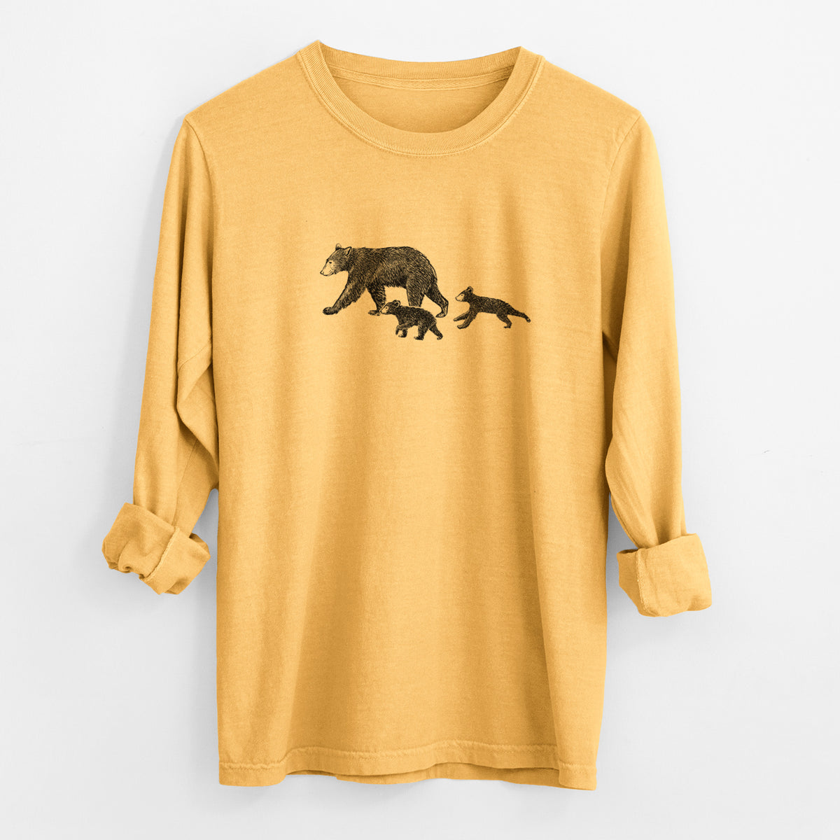 Golden wheat yellow Comfort Colors long sleeve shirt laid flat with the cuffs rolled, printed with a black ink illustration of a mother black bear walking with two cubs.