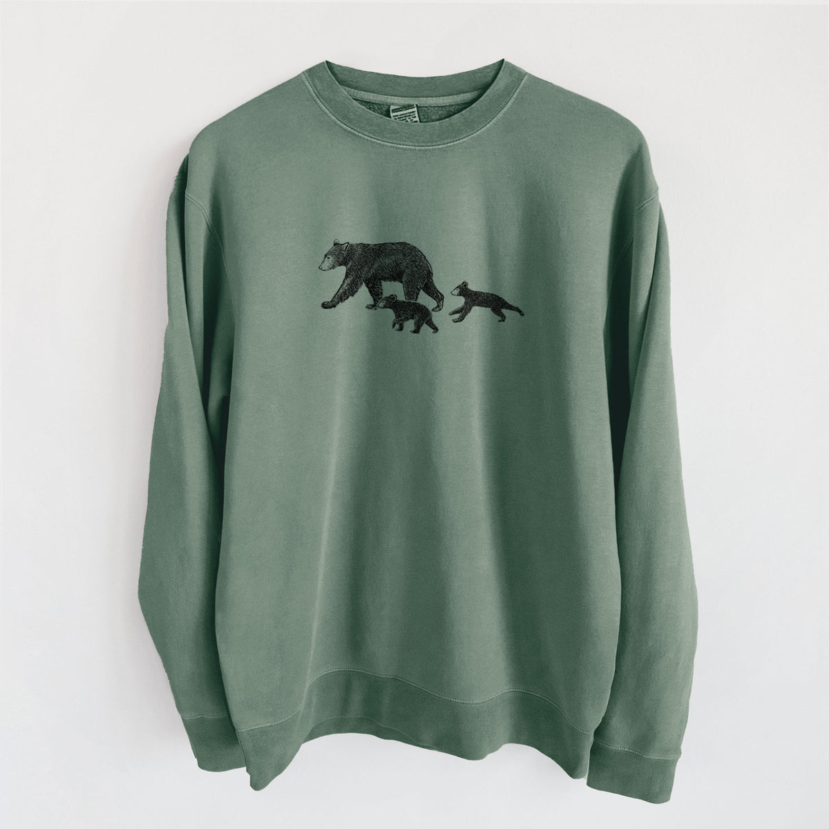 Alpine green pigment dyed crewneck sweatshirt laid flat, printed with a black ink illustration of a mother black bear walking with two cubs.