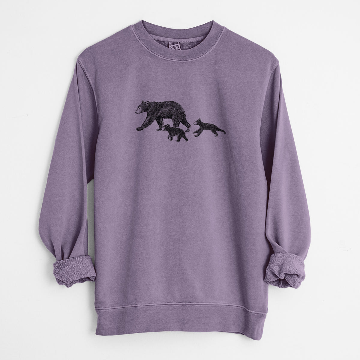 Plum purple pigment dyed crewneck sweatshirt laid flat with the sleeves rolled, printed with a black ink illustration of a mother black bear walking with two cubs.