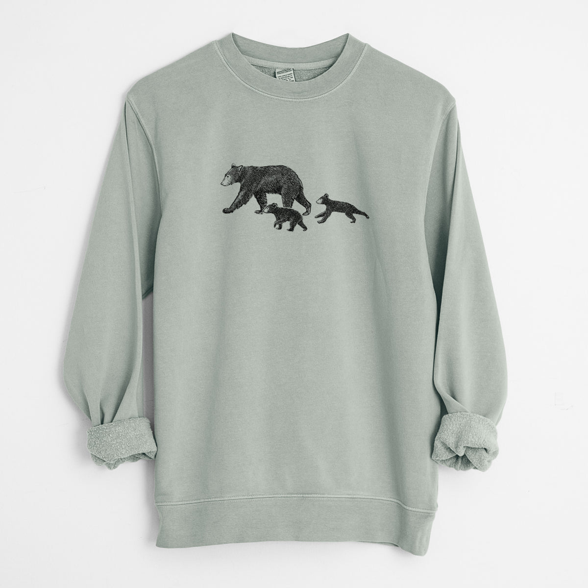 Sage green pigment dyed crewneck sweatshirt laid flat with the sleeves rolled, printed with a black ink illustration of a mother black bear walking with two cubs.