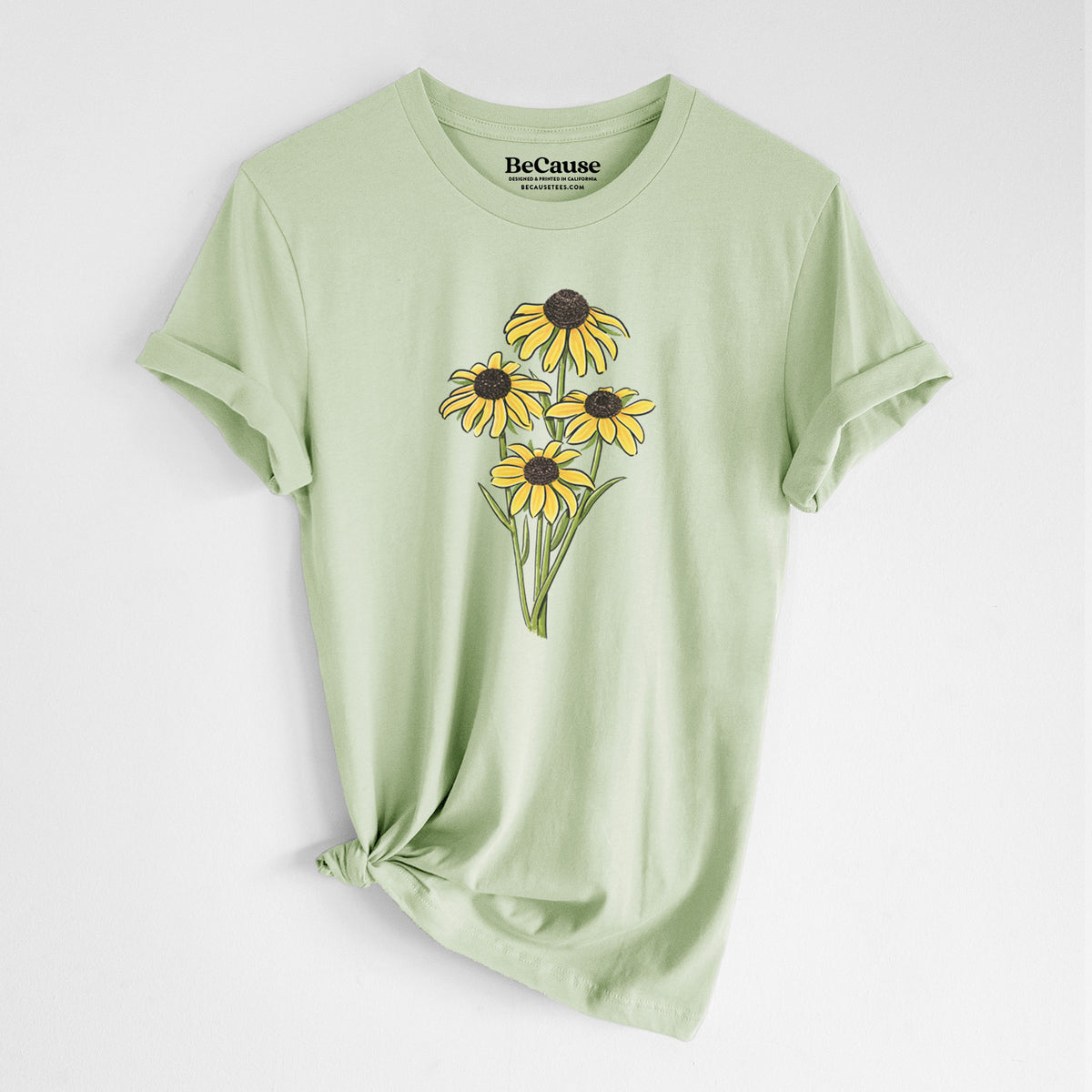 Spring green lightweight cotton t-shirt laid flat with the sleeves rolled, printed with a full-color bouquet of yellow black-eyed Susan flowers.