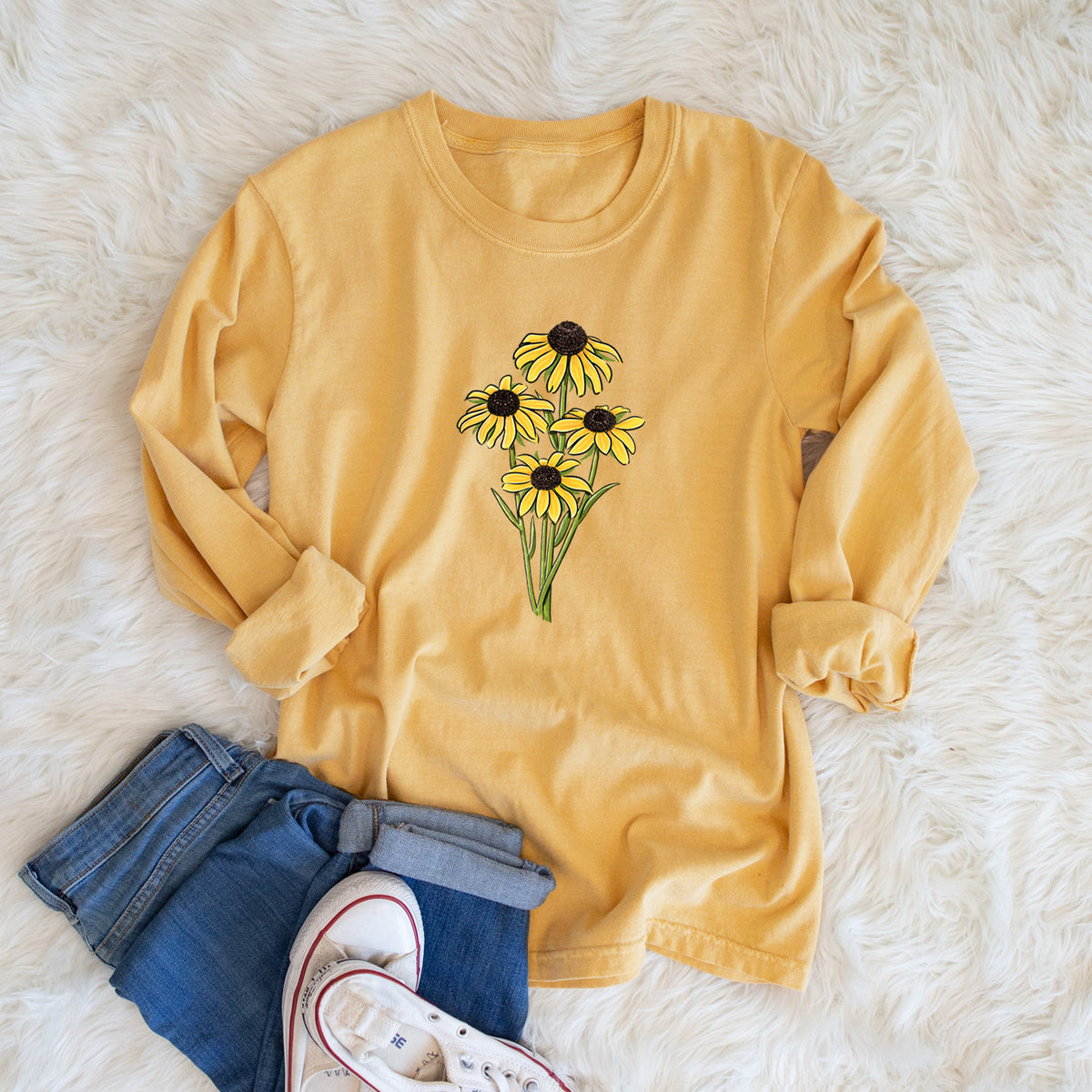 Golden wheat yellow Comfort Colors long sleeve shirt printed with a full-color bouquet of yellow black-eyed Susan flowers, shown in a lifestyle photo.