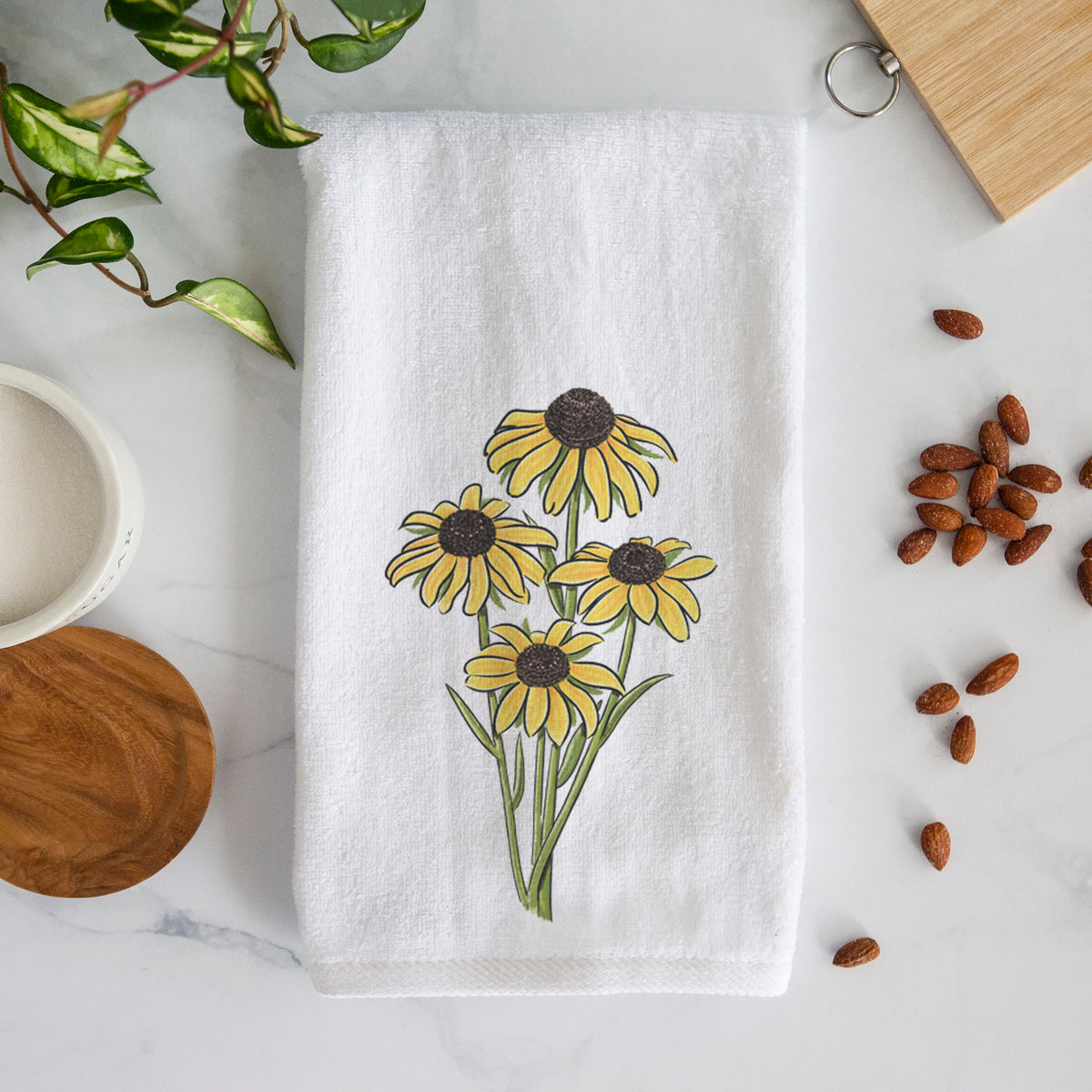 White hand towel printed with a full-color bouquet of yellow black-eyed Susan flowers.