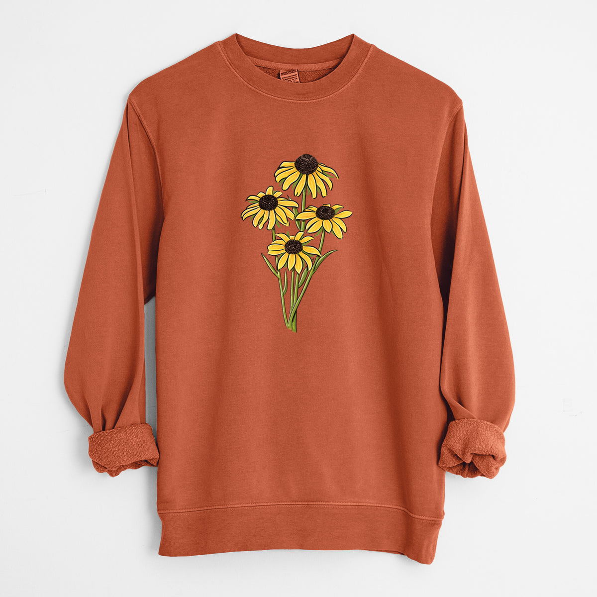 Amber orange pigment dyed crewneck sweatshirt laid flat with the sleeves rolled, printed with a full-color bouquet of yellow black-eyed Susan flowers.