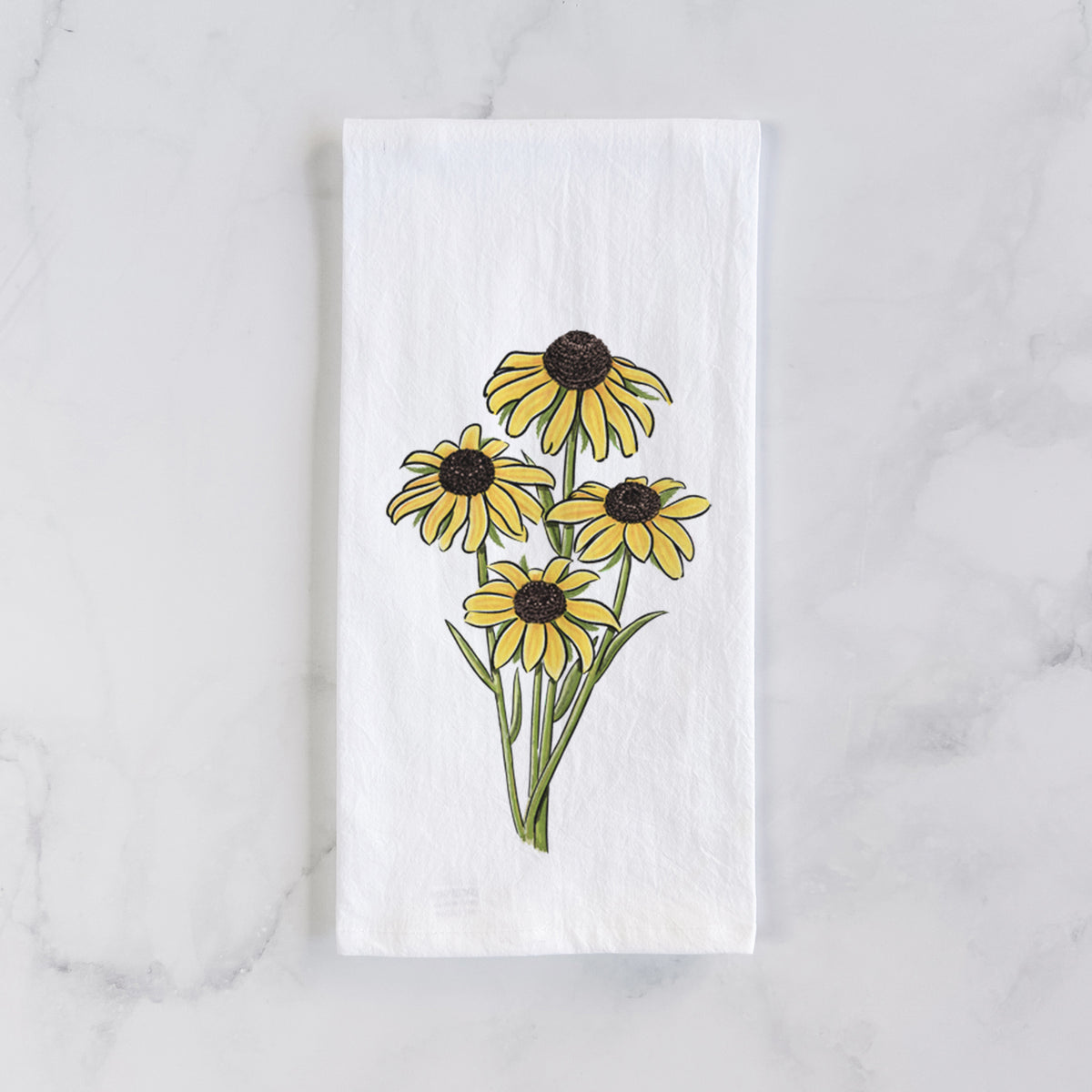White cotton tea towel laid flat on marble, printed with a full-color bouquet of yellow black-eyed Susan flowers.