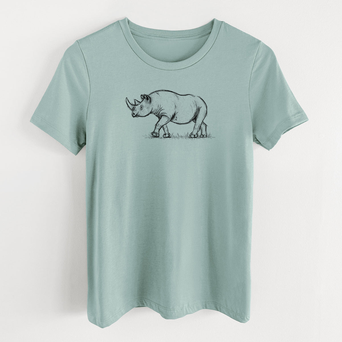 Dusty blue women's relaxed fit cotton t-shirt laid flat, printed with a black ink illustration of a black rhinoceros walking.