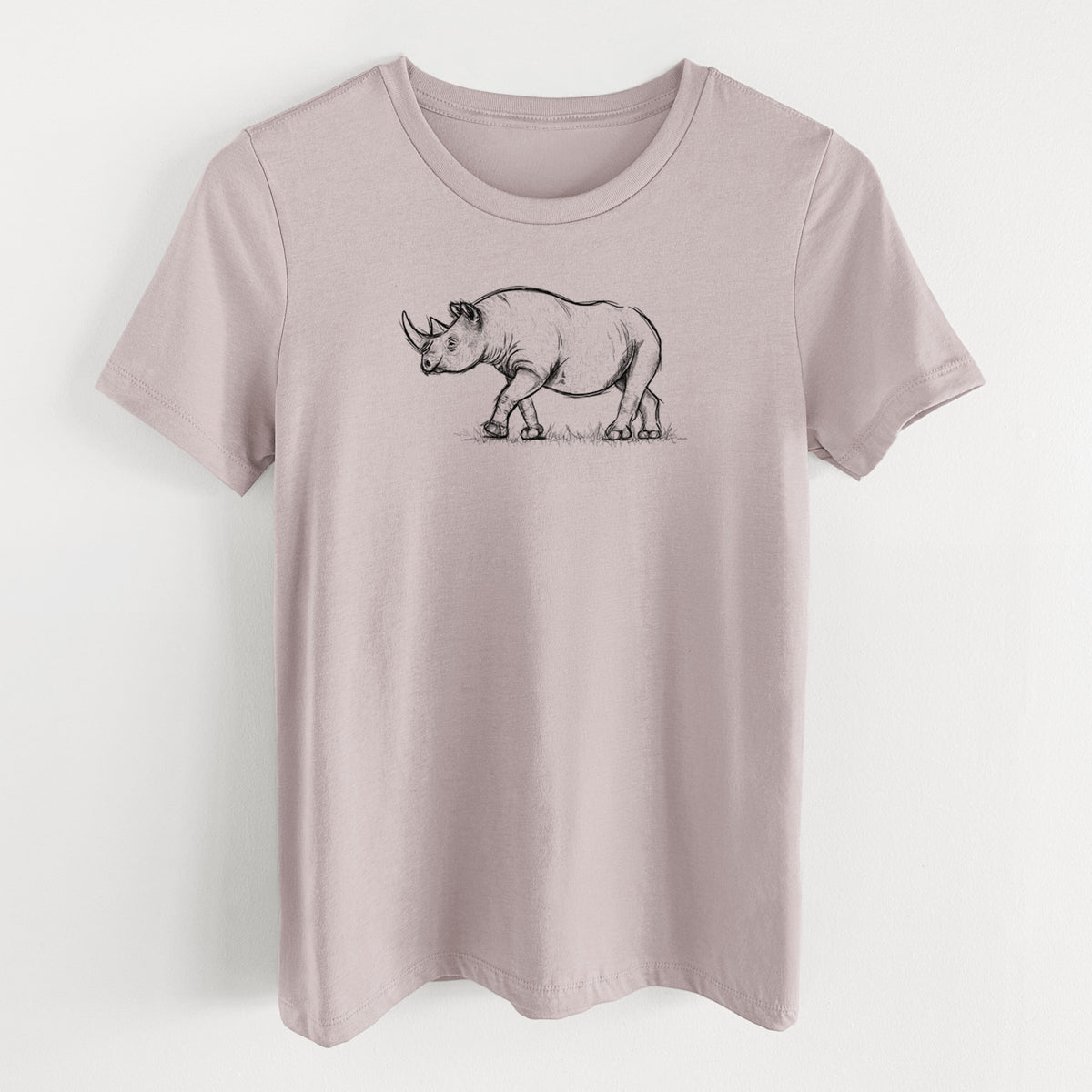 Pink gravel women's relaxed fit cotton t-shirt laid flat, printed with a black ink illustration of a black rhinoceros walking.