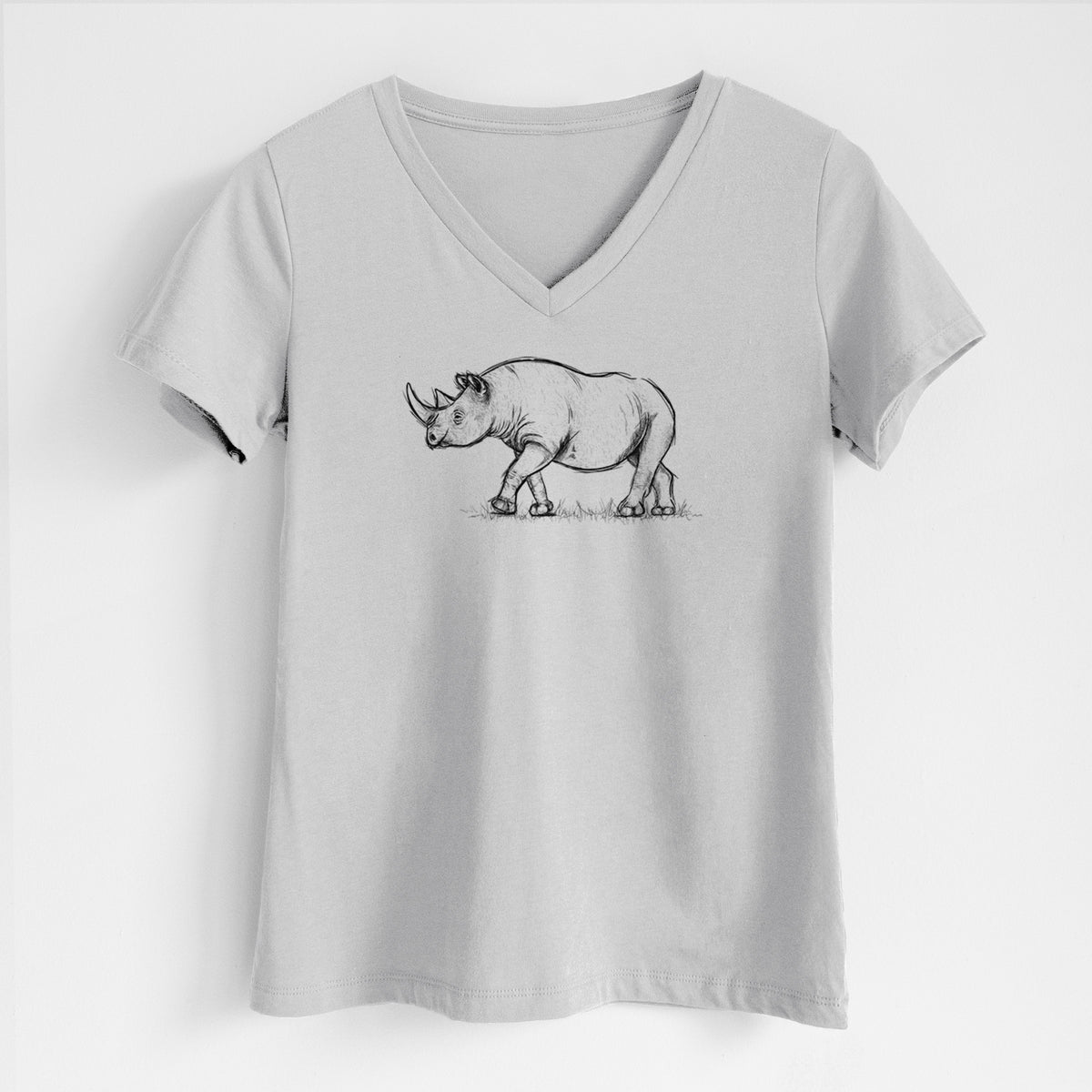 Lunar grey women's relaxed fit cotton V-neck t-shirt laid flat, printed with a black ink illustration of a black rhinoceros walking.