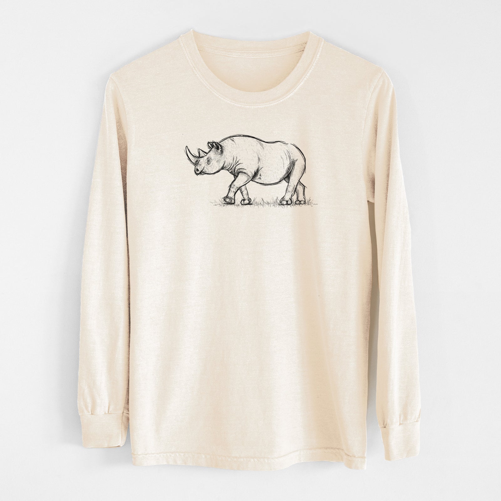 Ivory Comfort Colors long sleeve shirt laid flat, printed with a black ink illustration of a black rhinoceros walking.