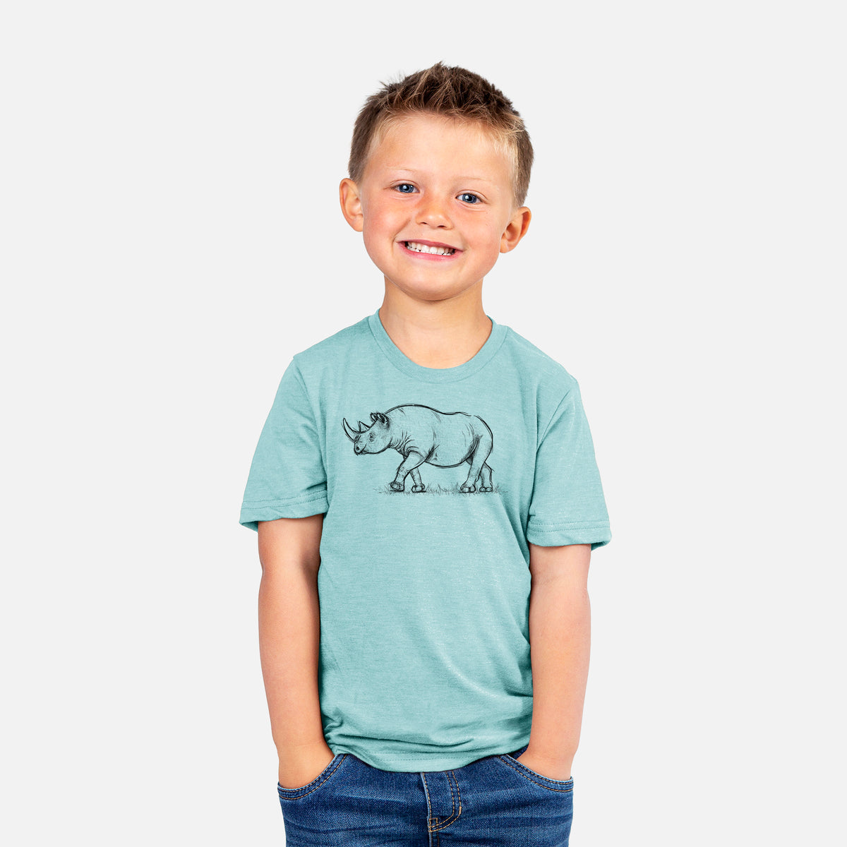 Smiling boy wearing a youth t-shirt printed with a black ink illustration of a black rhinoceros walking.