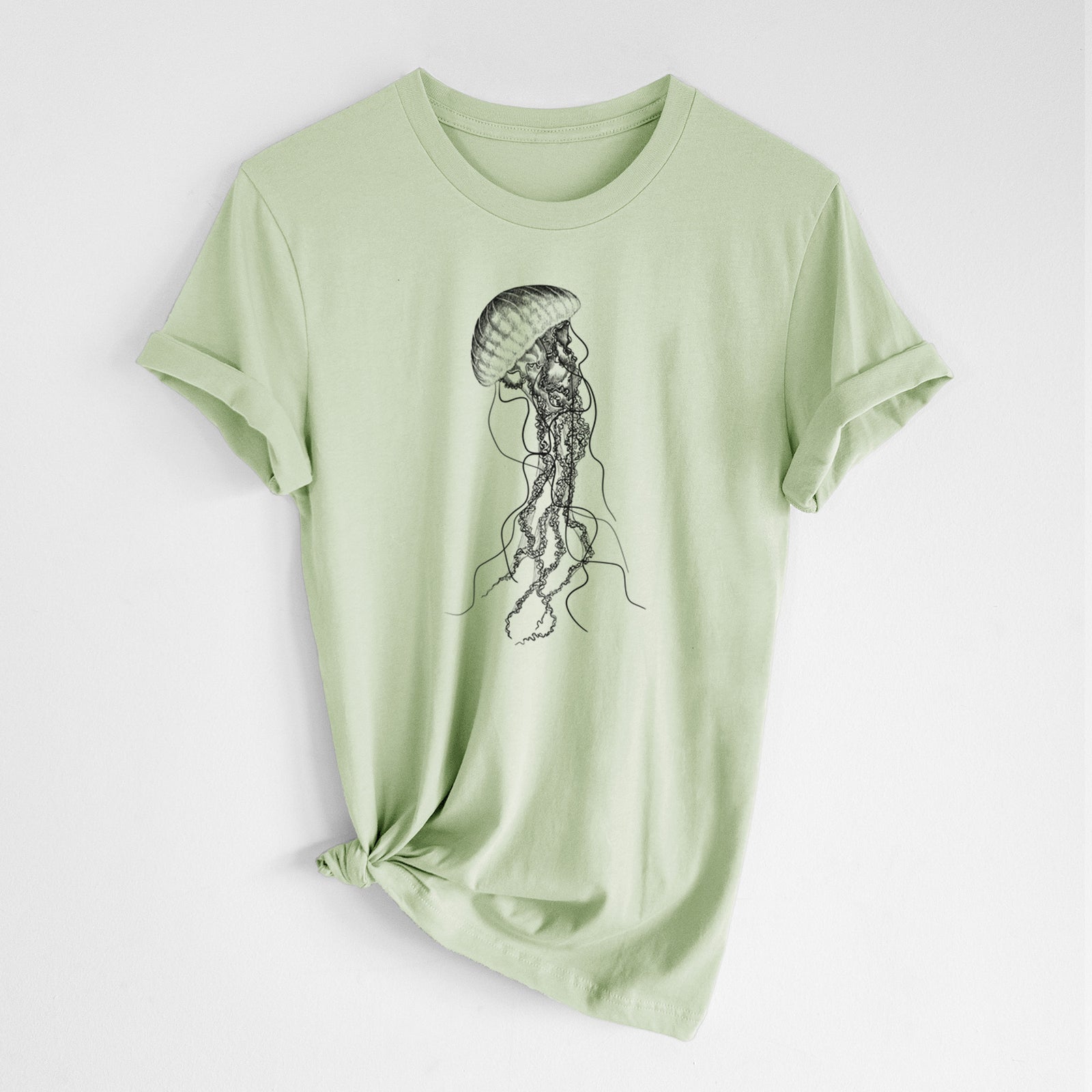 Spring green lightweight cotton t-shirt laid flat with the sleeves rolled, printed with a black ink illustration of a black sea nettle jellyfish with long trailing tentacles.