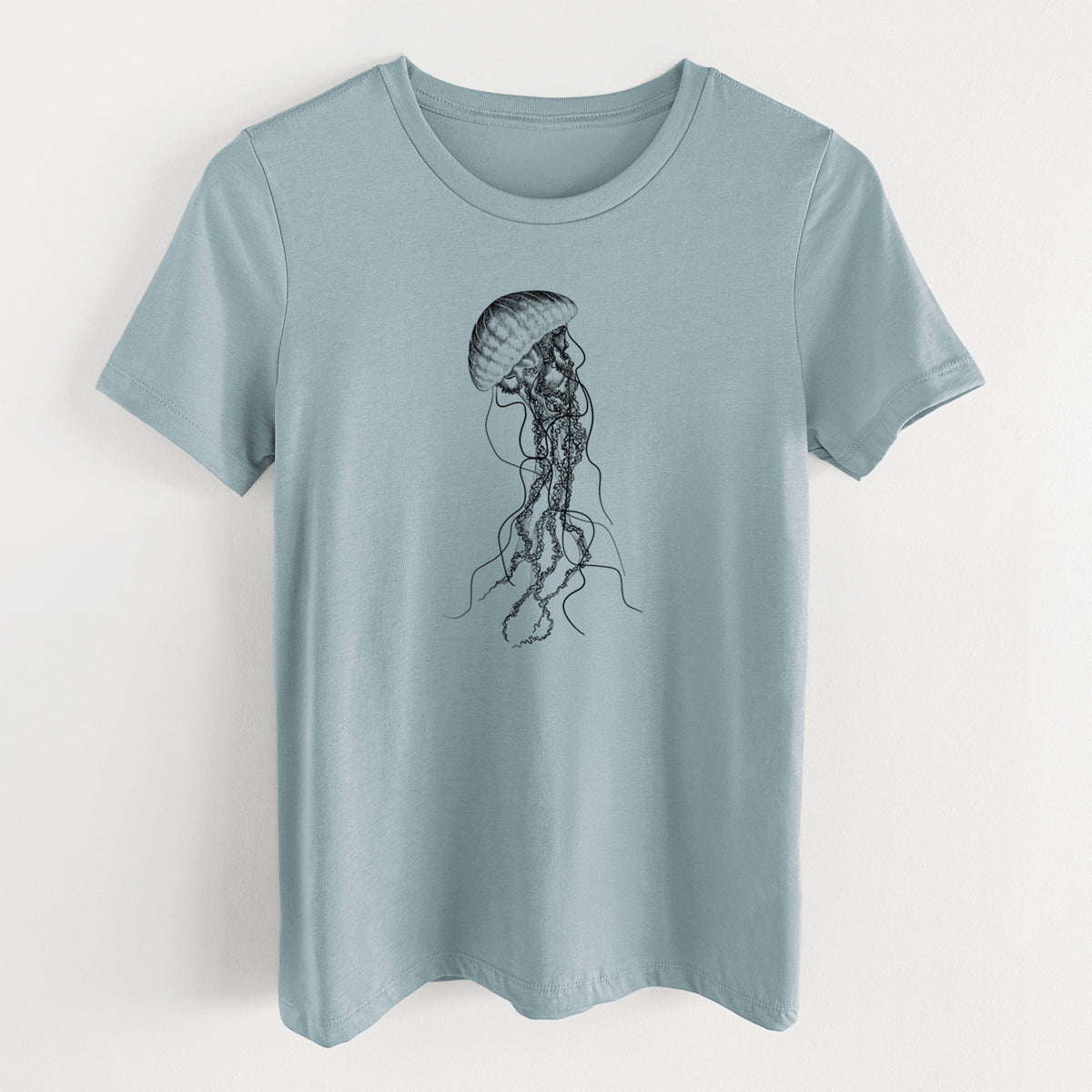 Vintage denim women's relaxed fit cotton t-shirt laid flat, printed with a black ink illustration of a black sea nettle jellyfish with long trailing tentacles.