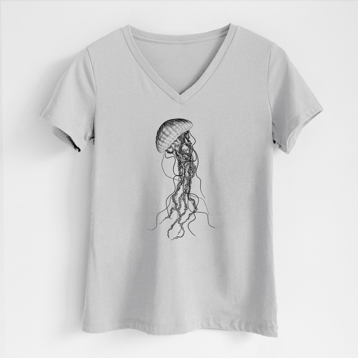 Lunar grey women's relaxed fit cotton V-neck t-shirt laid flat, printed with a black ink illustration of a black sea nettle jellyfish with long trailing tentacles.