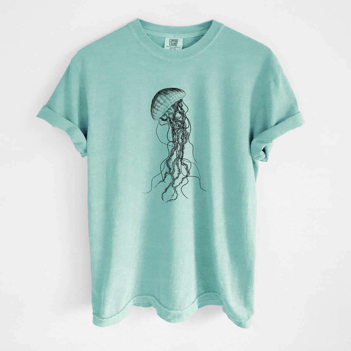 Chalky mint Comfort Colors t-shirt laid flat, printed with a black ink illustration of a black sea nettle jellyfish with long trailing tentacles.