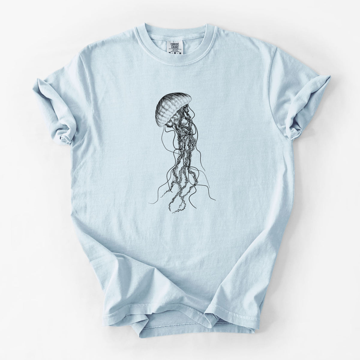 Chambray blue Comfort Colors t-shirt laid flat, printed with a black ink illustration of a black sea nettle jellyfish with long trailing tentacles.