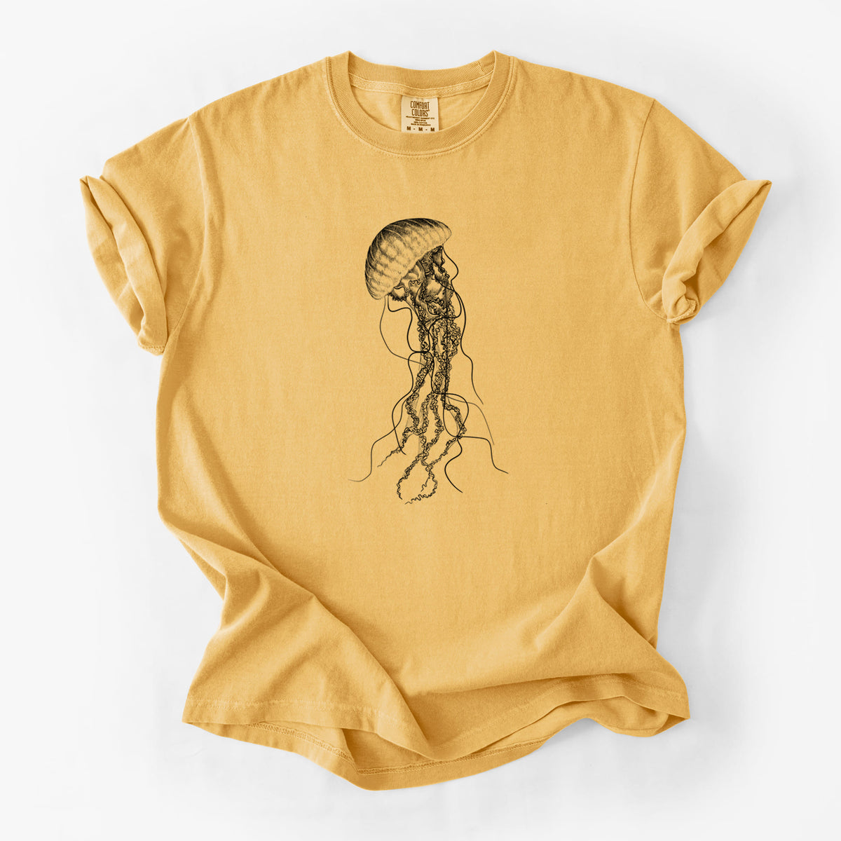 Golden wheat yellow Comfort Colors t-shirt laid flat, printed with a black ink illustration of a black sea nettle jellyfish with long trailing tentacles.
