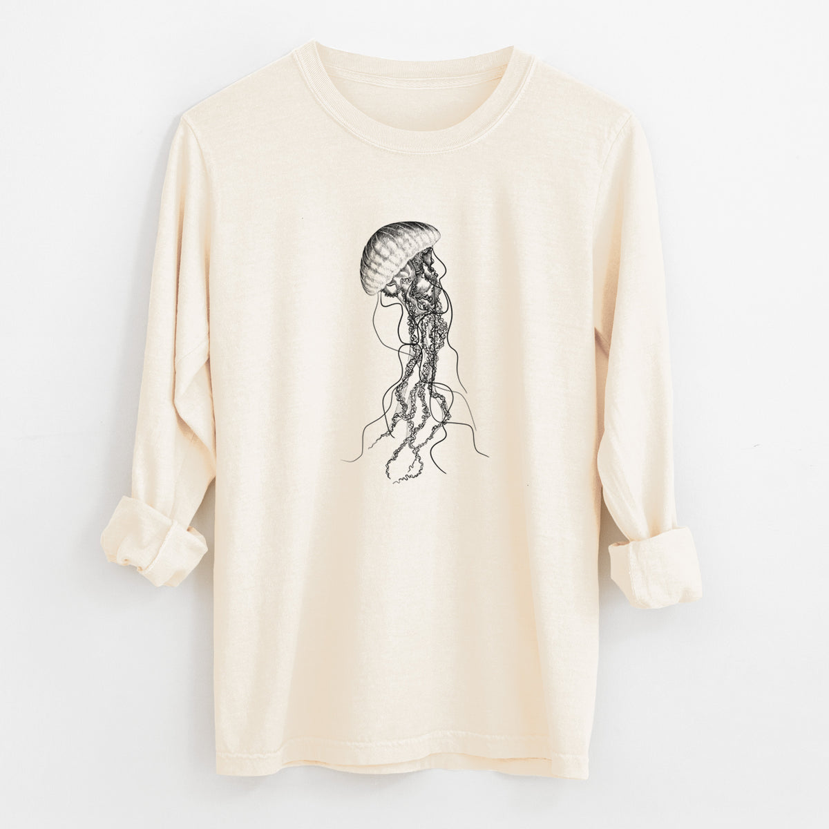 Ivory Comfort Colors long sleeve shirt laid flat with the cuffs rolled, printed with a black ink illustration of a black sea nettle jellyfish with long trailing tentacles.