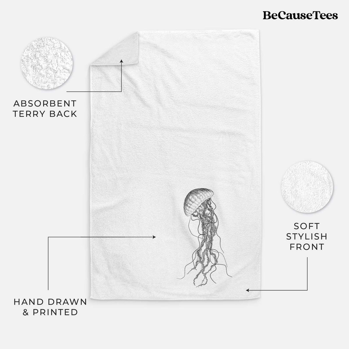 White hand towel printed with a black ink illustration of a black sea nettle jellyfish with long trailing tentacles.