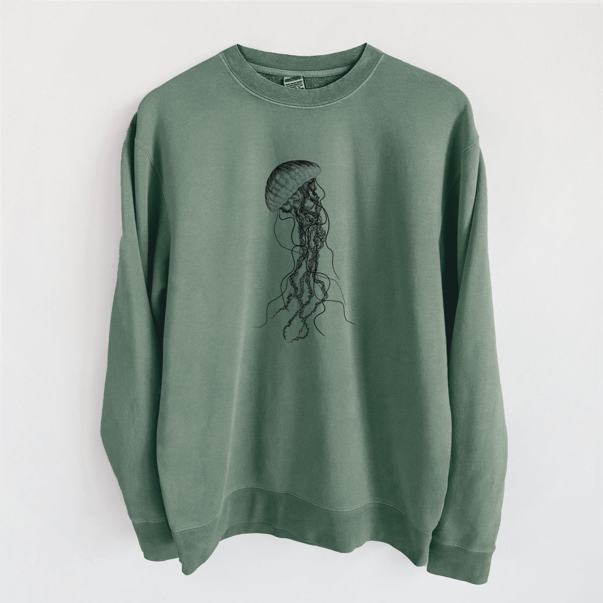 Alpine green pigment dyed crewneck sweatshirt laid flat, printed with a black ink illustration of a black sea nettle jellyfish with long trailing tentacles.