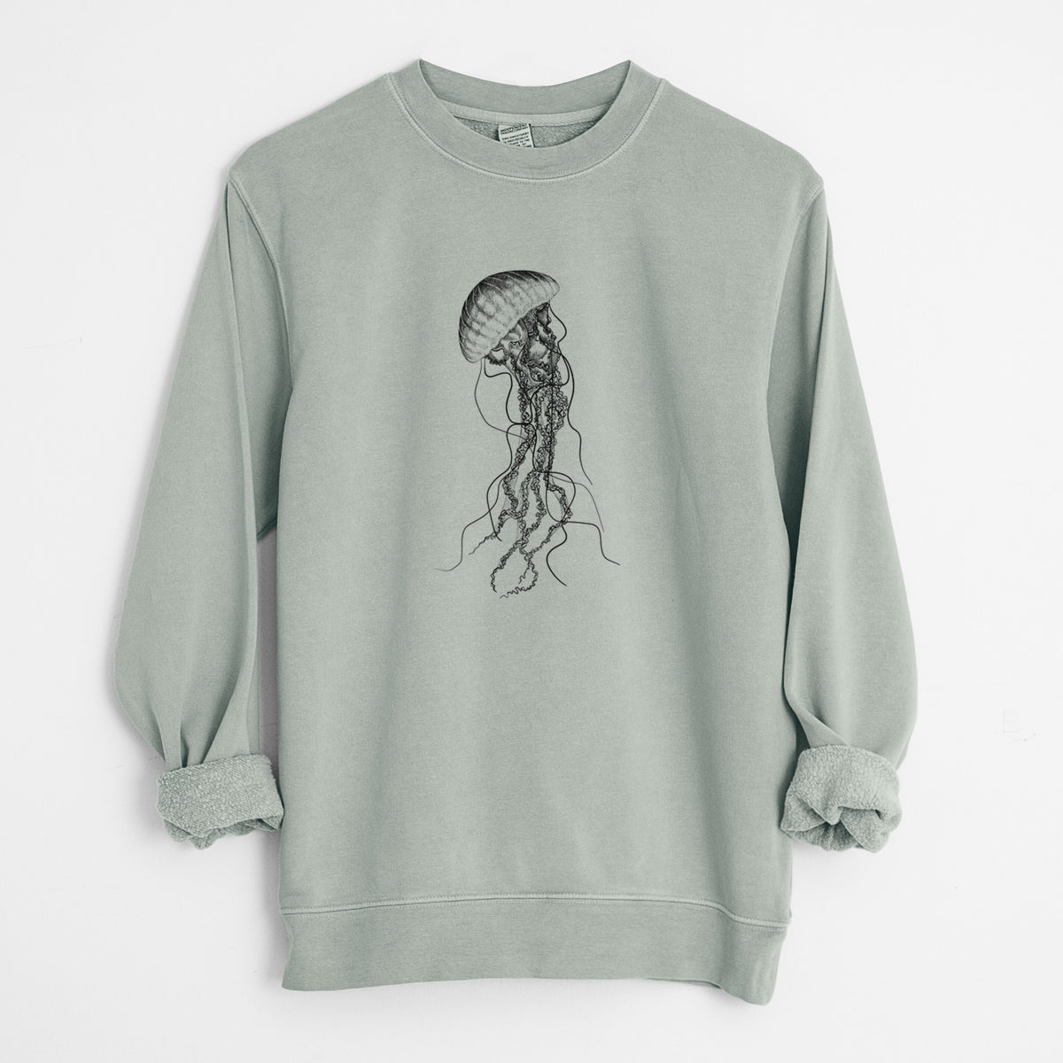 Sage green pigment dyed crewneck sweatshirt laid flat with the sleeves rolled, printed with a black ink illustration of a black sea nettle jellyfish with long trailing tentacles.