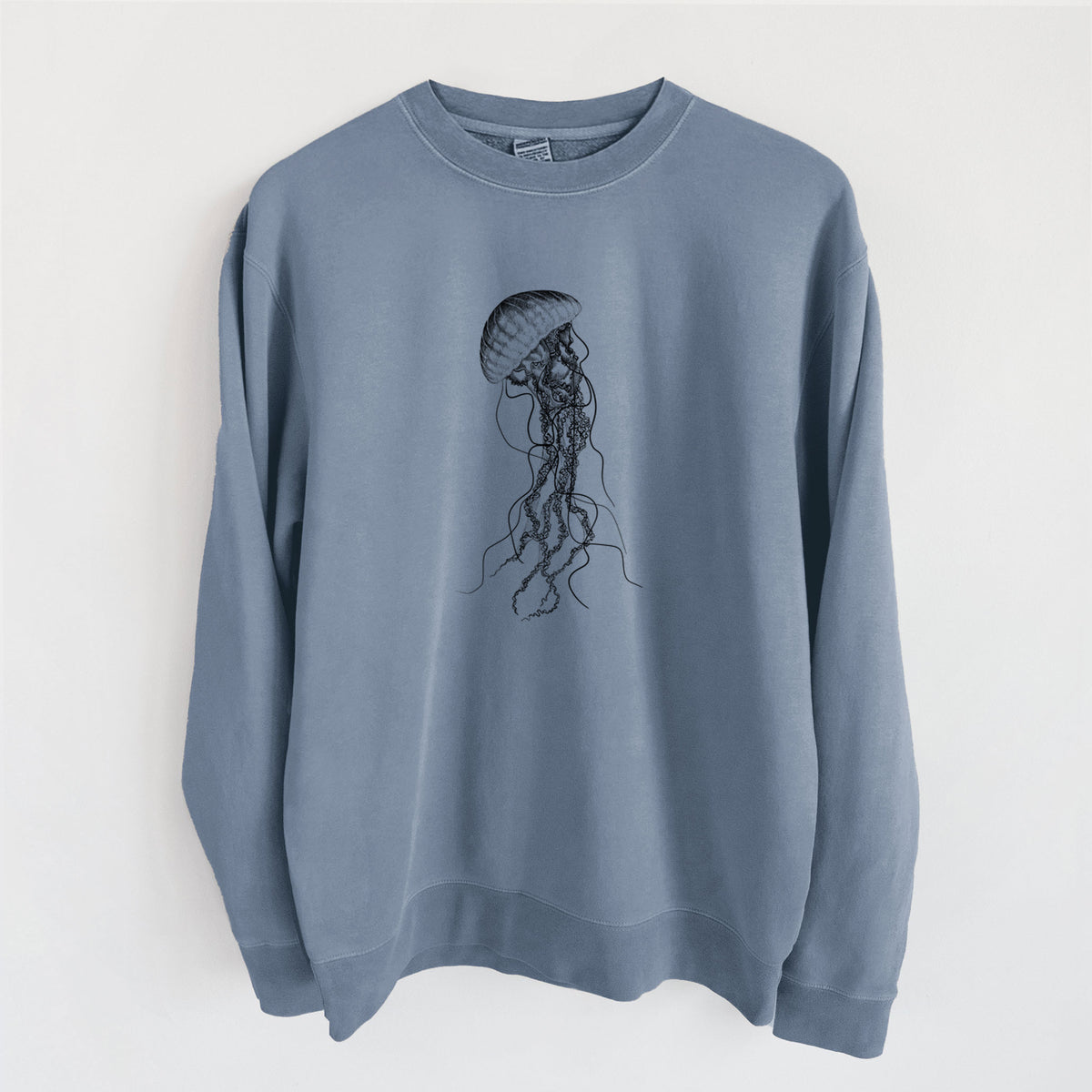 Slate blue pigment dyed crewneck sweatshirt laid flat, printed with a black ink illustration of a black sea nettle jellyfish with long trailing tentacles.