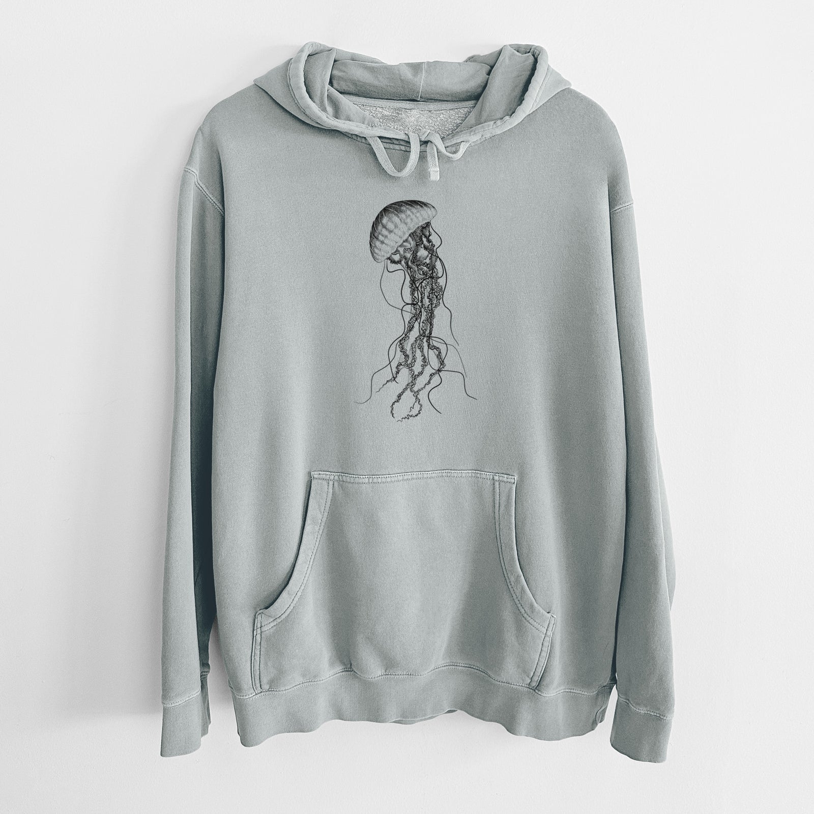 Sage green pigment dyed hoodie laid flat, printed with a black ink illustration of a black sea nettle jellyfish with long trailing tentacles.