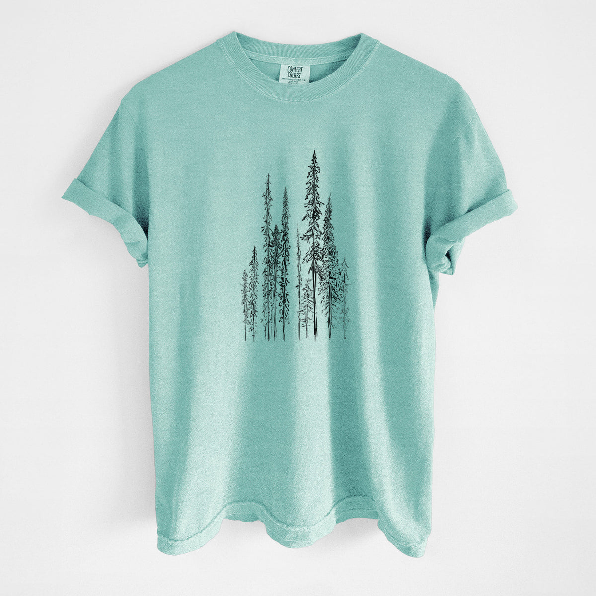 Chalky mint Comfort Colors t-shirt laid flat, printed with a black ink illustration of a stand of tall, narrow black spruce trees.