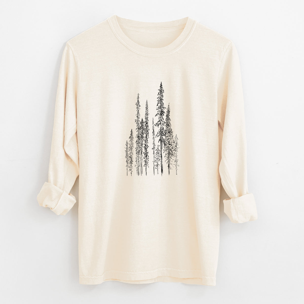 Ivory Comfort Colors long sleeve shirt laid flat with the cuffs rolled, printed with a black ink illustration of a stand of tall, narrow black spruce trees.