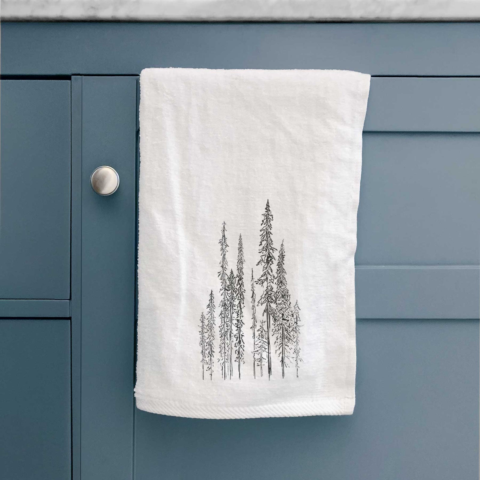 White hand towel printed with a black ink illustration of a stand of tall, narrow black spruce trees.