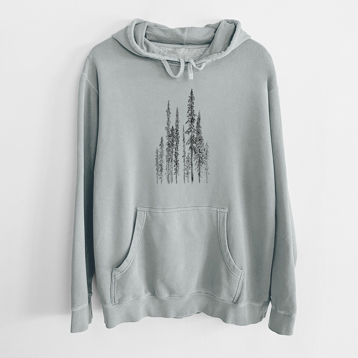 Sage green pigment dyed hoodie laid flat, printed with a black ink illustration of a stand of tall, narrow black spruce trees.