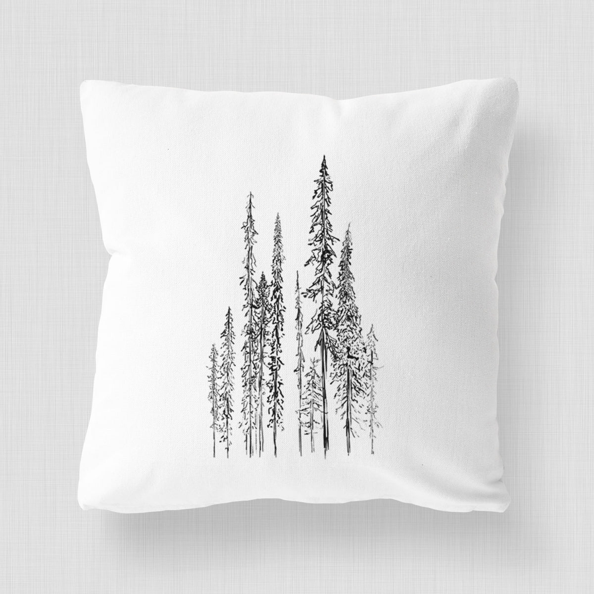 White pillow cover printed with a black ink illustration of a stand of tall, narrow black spruce trees.