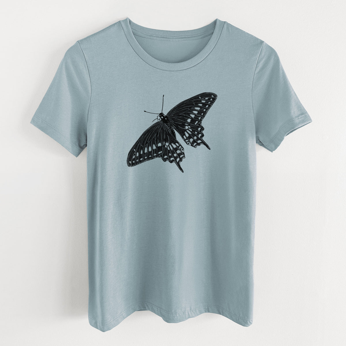 Vintage denim women's relaxed fit cotton t-shirt laid flat, printed with a detailed black ink illustration of a black swallowtail butterfly with its wings spread.