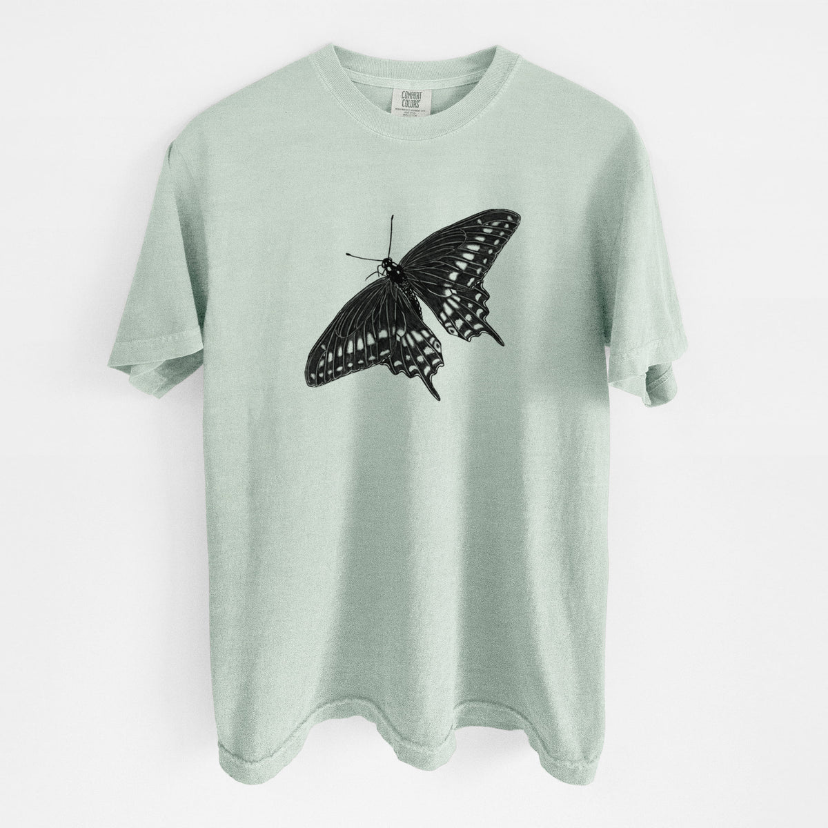 Bay green Comfort Colors t-shirt laid flat, printed with a detailed black ink illustration of a black swallowtail butterfly with its wings spread.