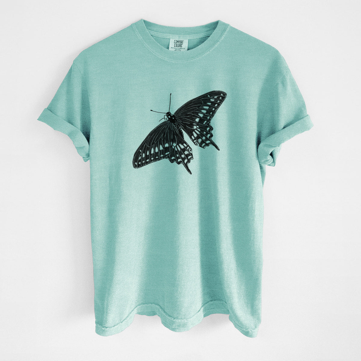 Chalky mint Comfort Colors t-shirt laid flat, printed with a detailed black ink illustration of a black swallowtail butterfly with its wings spread.