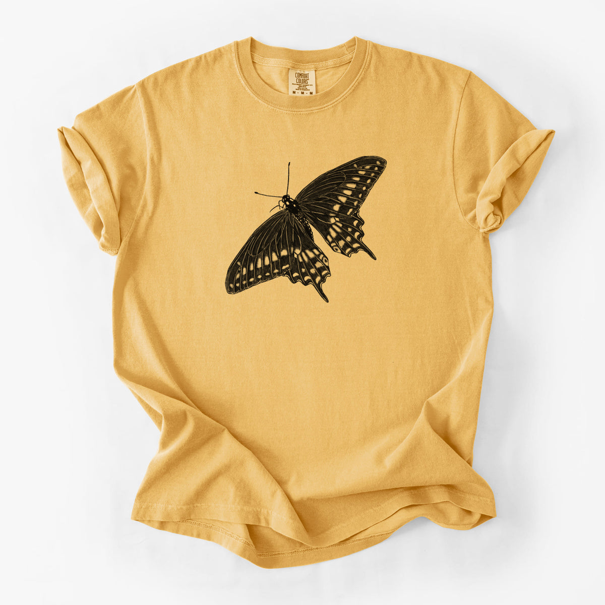 Golden wheat yellow Comfort Colors t-shirt laid flat, printed with a detailed black ink illustration of a black swallowtail butterfly with its wings spread.