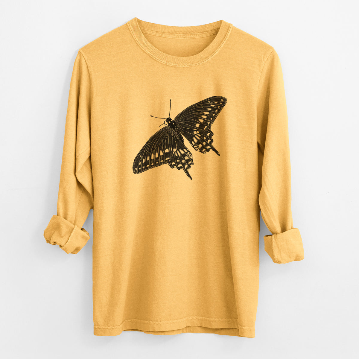 Golden wheat yellow Comfort Colors long sleeve shirt laid flat with the cuffs rolled, printed with a detailed black ink illustration of a black swallowtail butterfly with its wings spread.