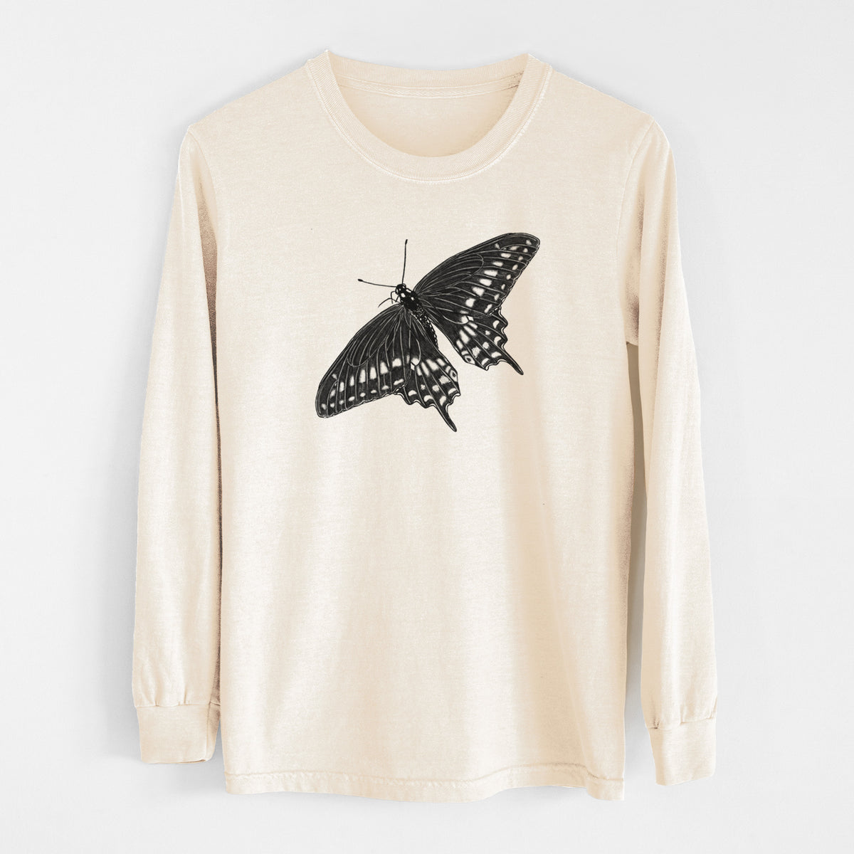 Ivory Comfort Colors long sleeve shirt laid flat, printed with a detailed black ink illustration of a black swallowtail butterfly with its wings spread.