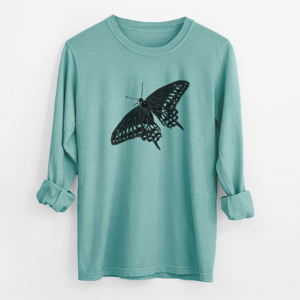 Reef green Comfort Colors long sleeve shirt laid flat with the cuffs rolled, printed with a detailed black ink illustration of a black swallowtail butterfly with its wings spread.