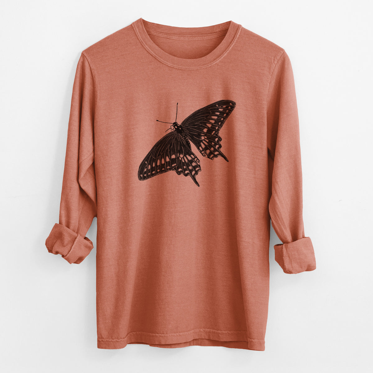 Yam burnt orange Comfort Colors long sleeve shirt laid flat with the cuffs rolled, printed with a detailed black ink illustration of a black swallowtail butterfly with its wings spread.