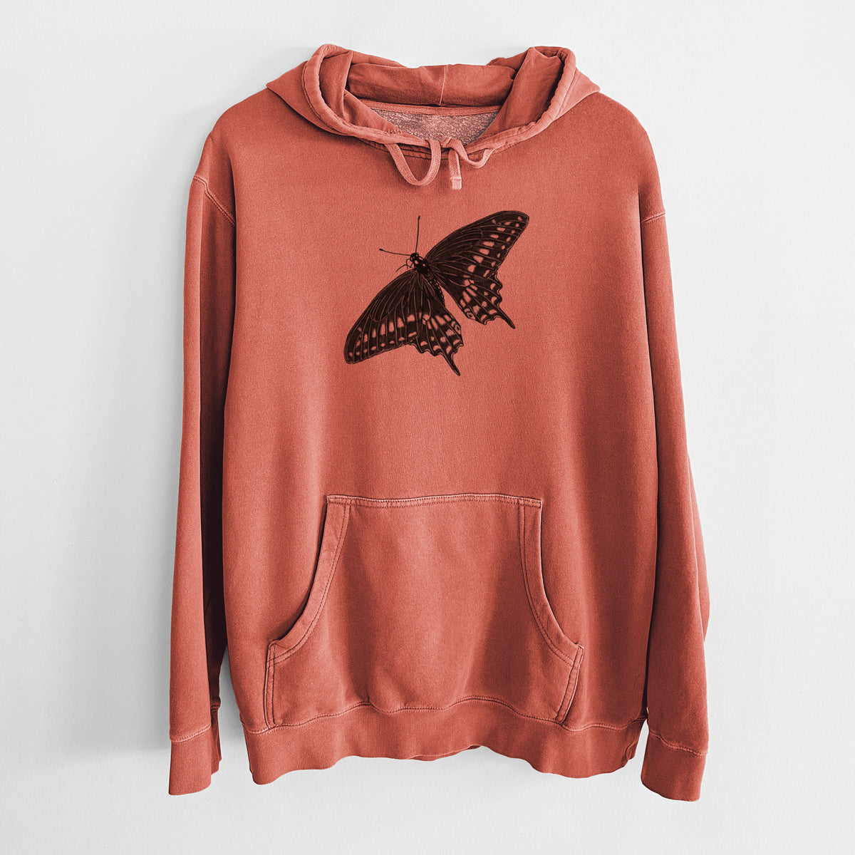 Amber orange pigment dyed hoodie laid flat, printed with a detailed black ink illustration of a black swallowtail butterfly with its wings spread.