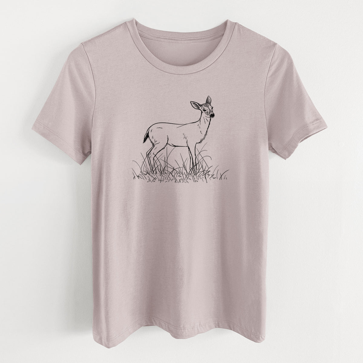 Pink gravel women's relaxed fit cotton t-shirt laid flat, printed with a black ink sketch of a black-tailed deer standing in tall grass.